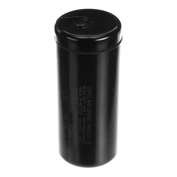 A black cylindrical object with some printed text on its side, likely an electronic component.