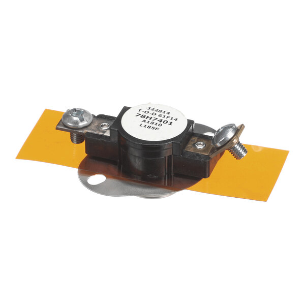 A small electronic component with a circular white label, two mounting screws, and an orange strip attached.