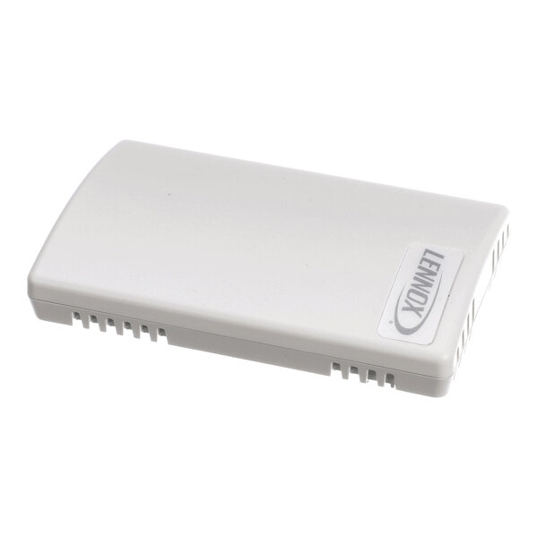 A rectangular white plastic device with vent-like openings and a label that reads 'LENNOX' on the top surface.