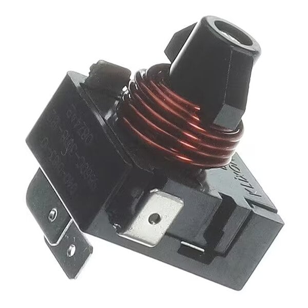 A close-up view of an electrical relay with a visible copper coil and black plastic housing.