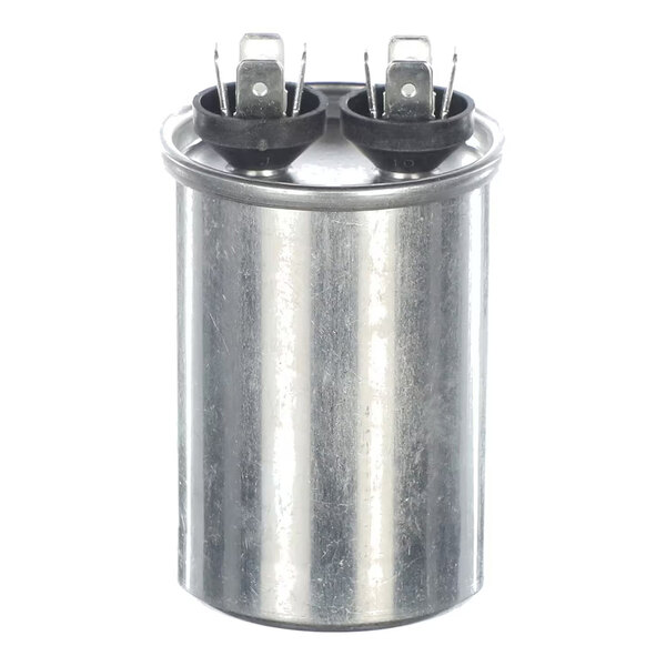 A cylindrical metallic component with two sets of electrical terminals on top, likely an electronic capacitor.