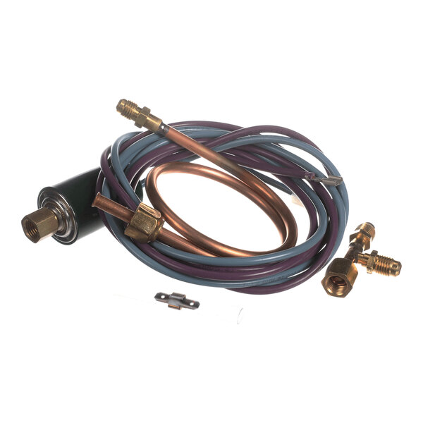 A coiled assembly of copper and plastic tubing with brass fittings and a small metal bracket, likely part of a refrigeration or HVAC system.