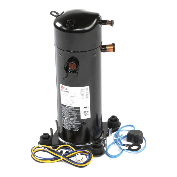 A black cylindrical mechanical component with attached wires and connectors, mounted on a base with four feet.