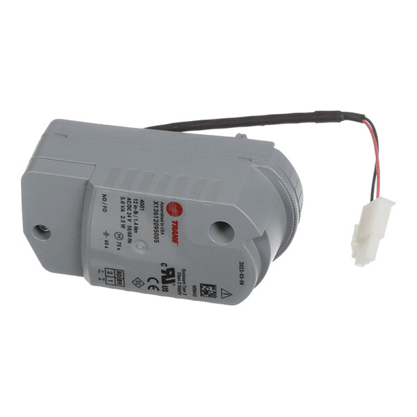 A gray electronic actuator with a label, wiring, and a white connector plug.