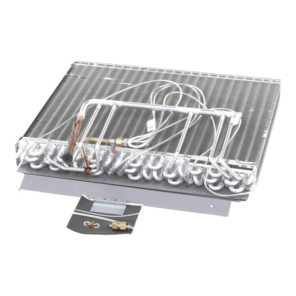 A metal coil assembly with multiple curved tubes and attached fittings, displayed on a white background with a small hardware kit in front.