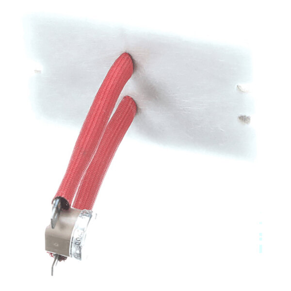 A rectangular metallic plate with two red insulated wires attached to a small metallic component.