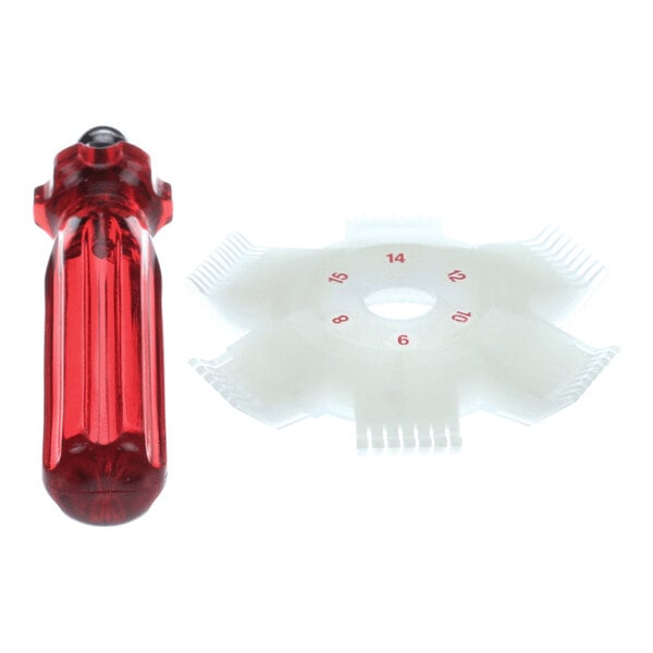 A red-handled tool and a white plastic comb-like gauge with numbered sections arranged in a circular pattern.
