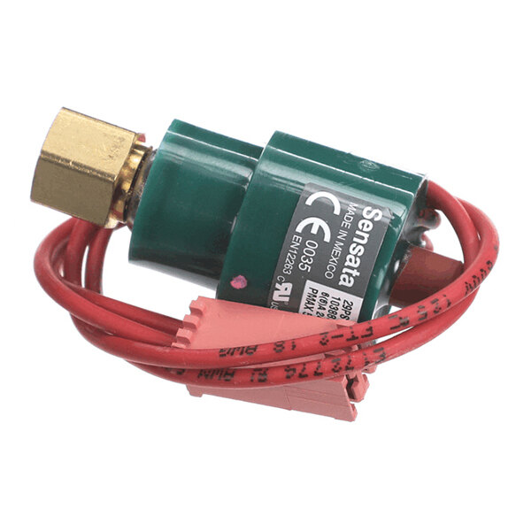A small cylindrical device with a brass fitting, green body, red wires, and a pink connector.