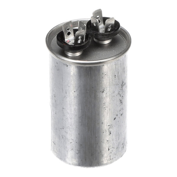 A cylindrical metal component with two sets of electrical terminals on top, likely a capacitor.
