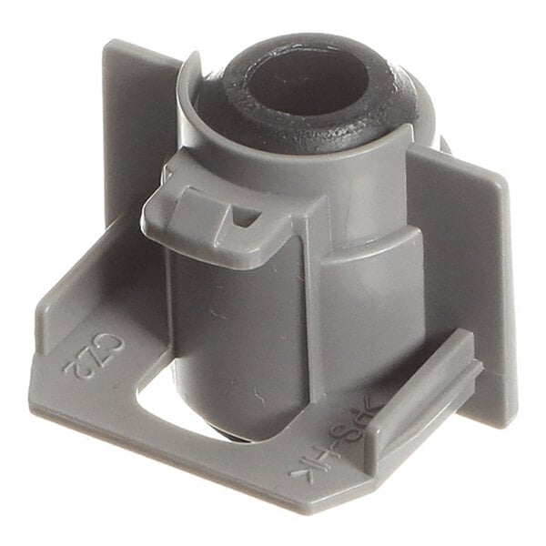 A gray plastic and rubber component with a cylindrical center and flat base, featuring raised side supports and molded markings.