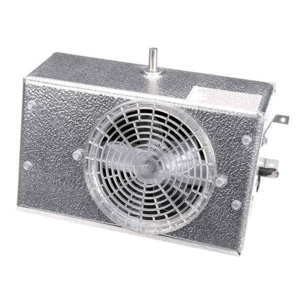A rectangular metallic device with a textured surface, featuring a circular fan covered by a protective grille on one side.