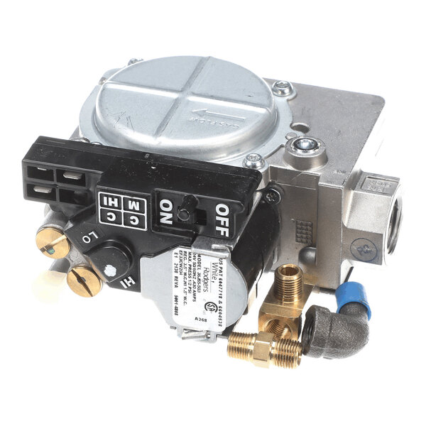 A metallic gas valve assembly with various control knobs, switches, and connection ports visible.