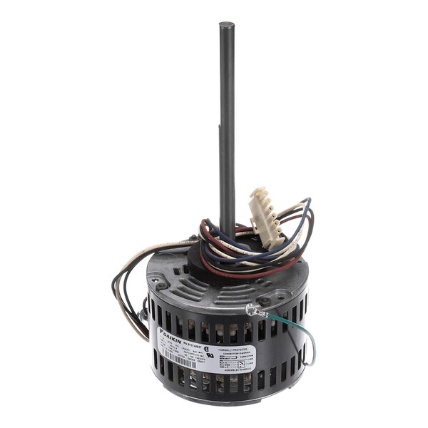 A cylindrical electric motor with a vertical shaft, attached wires, and a label on the side.