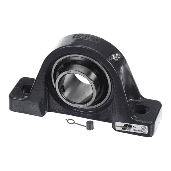 A black cast iron pillow block bearing with a cylindrical metal insert and mounting holes on both sides, shown with a small cap and pin in front.