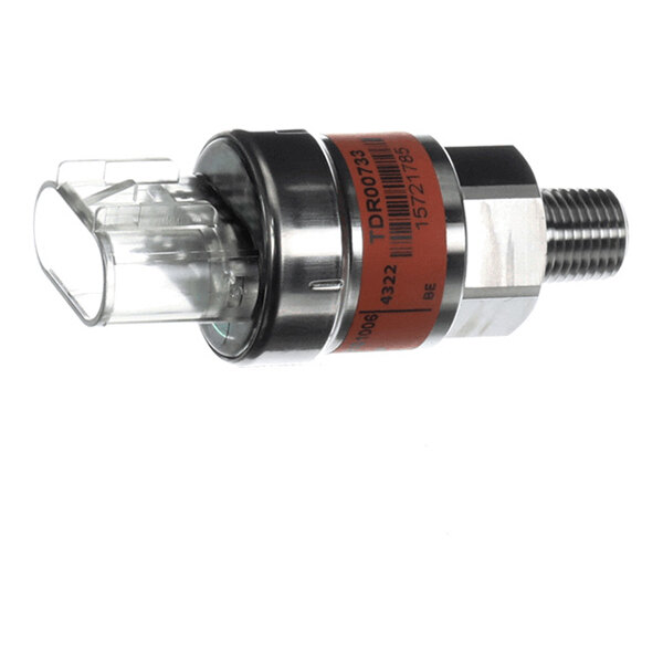 A cylindrical metal component with a threaded end and a clear plastic connector, featuring a red label with text and barcodes.