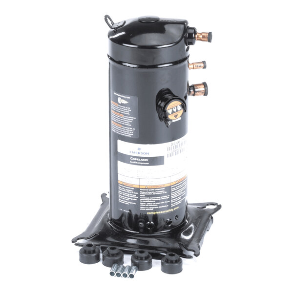 A black cylindrical mechanical component with copper pipe fittings and a label, mounted on a square metal base with rubber mounts and metal sleeves in front.