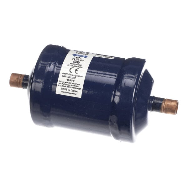 A cylindrical, dark blue metal component with copper pipe fittings on both ends and a white label with technical information.