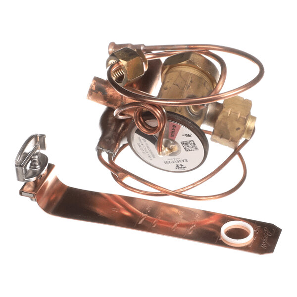 A brass and copper valve assembly with coiled tubing and a metal mounting bracket.