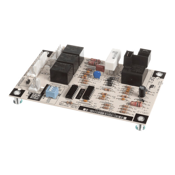 A rectangular electronic circuit board with various components including relays, resistors, capacitors, connectors, and integrated circuits mounted on it.