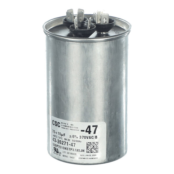 A cylindrical metal component with three electrical terminals on top and a label with technical specifications on the side.