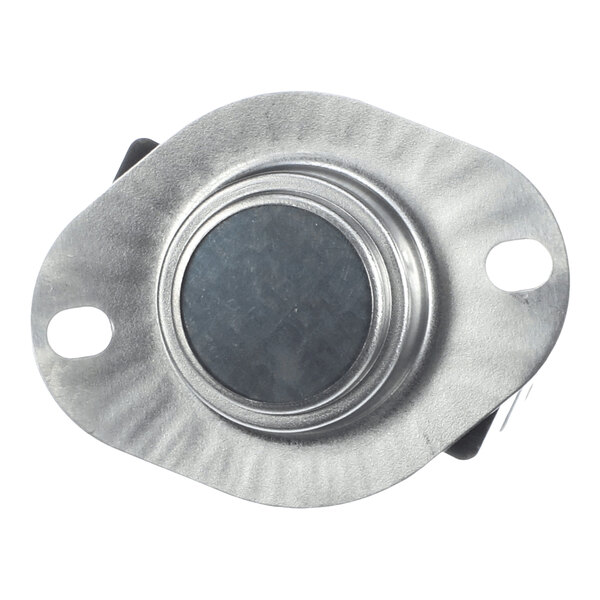 A round metallic component with two mounting holes and a central circular area, likely part of an electrical or mechanical assembly.