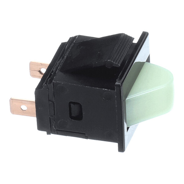 A black rectangular electrical switch with a greenish translucent button and two metal prongs for connections.