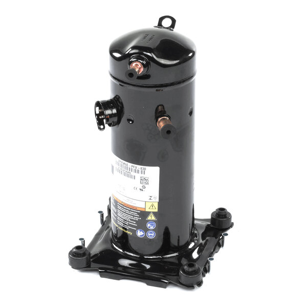 A black cylindrical metal component with copper pipe fittings and a label, mounted on a square base with four feet.