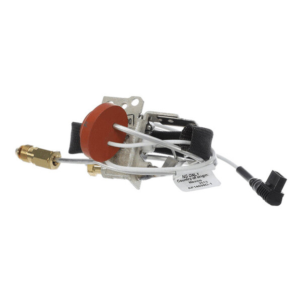 A metal and plastic assembly with wires, a red circular component, a brass fitting, and a black connector, likely part of a mechanical or electronic system.