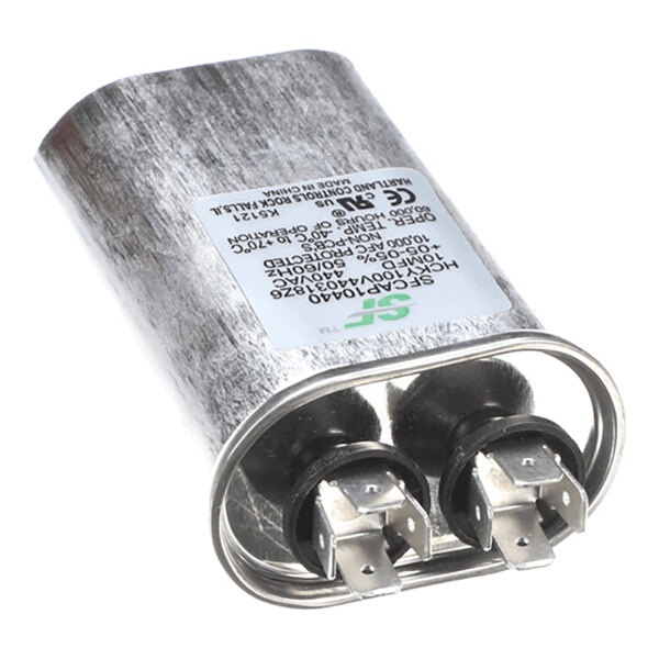 A metallic cylindrical capacitor with two pairs of electrical terminals and a label displaying technical specifications.