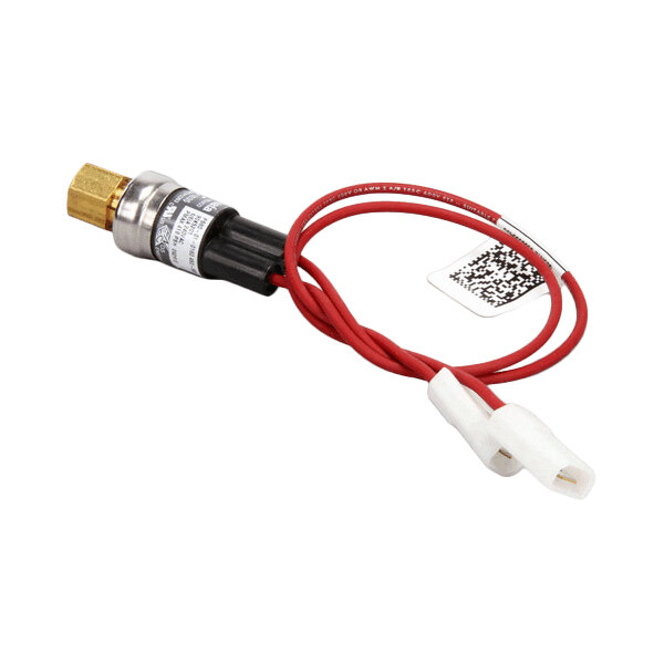 A small electronic component with a brass fitting, black cylindrical body, red wires, and white connectors, along with a tag featuring a QR code.