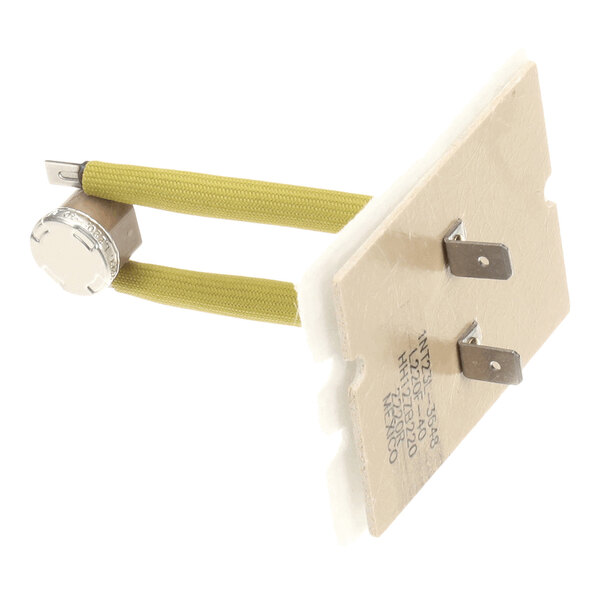 A metal and ceramic component with two yellow insulated wires, a round metallic cap, and two flat metal terminals.