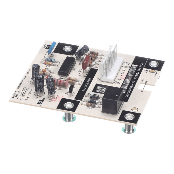 A rectangular electronic circuit board with various components including capacitors, resistors, an integrated circuit, a relay, and a white multi-pin connector, mounted on metal standoffs.