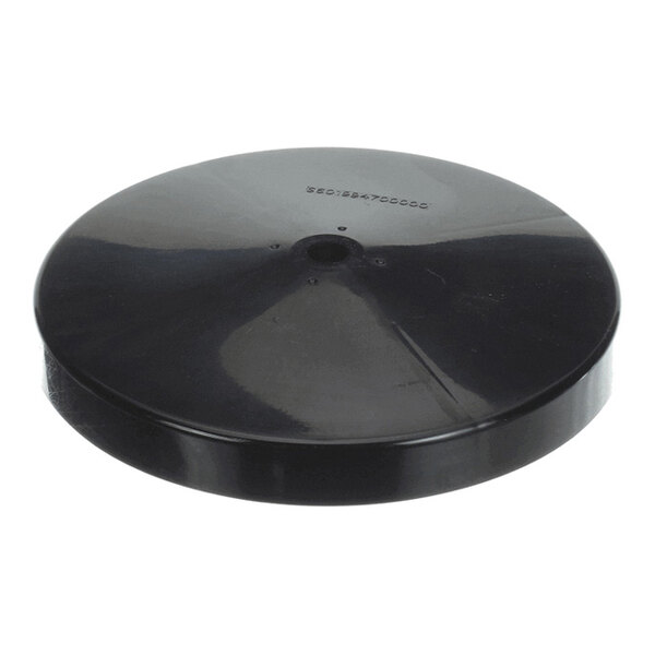 A round, black, flat disc with a slightly raised center and a small hole in the middle, resembling a protective cover or shield.