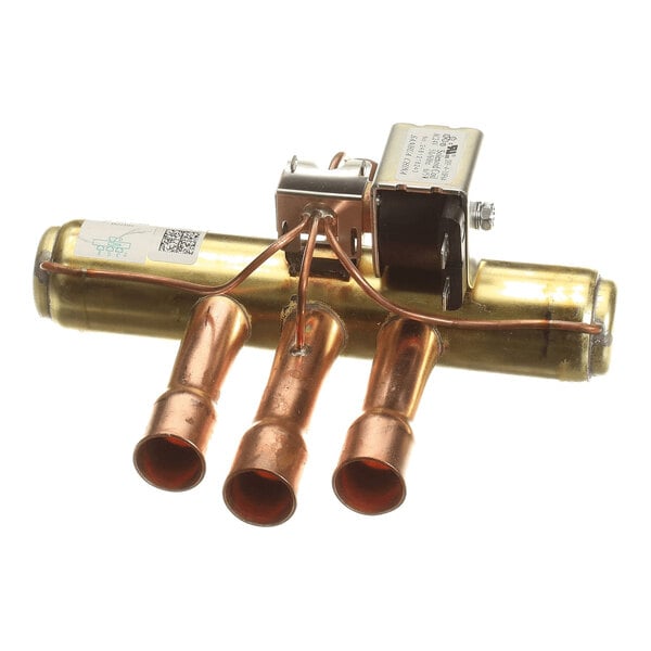 A metallic component with three copper pipe outlets, a cylindrical brass body, and an attached solenoid valve on top.