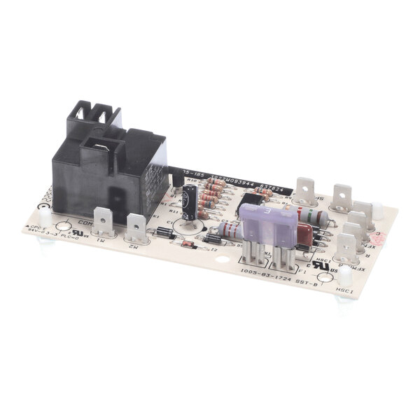 An electronic circuit board with various components including a black relay, resistors, capacitors, and terminal connectors.