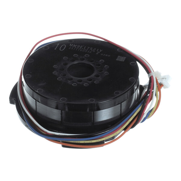 A round black electronic component with multiple colored wires attached, likely a motor or similar device.
