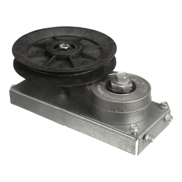 A metal and plastic mechanical assembly featuring a large black pulley wheel mounted on a rectangular metal base with bolts and a smaller round metal component.