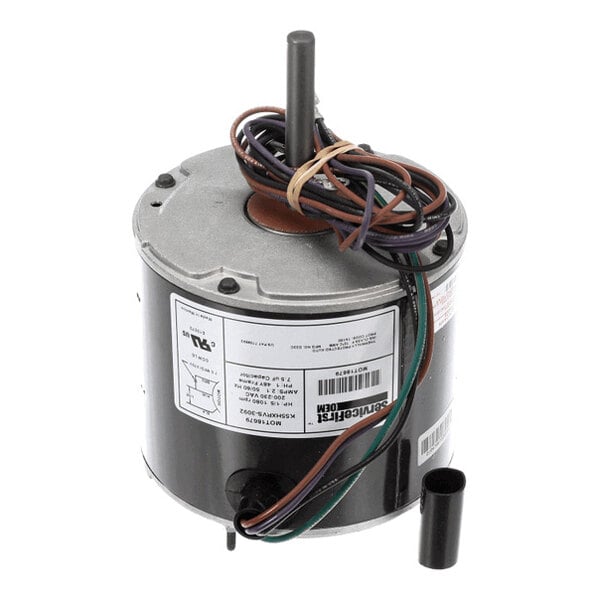 A cylindrical electric motor with a central shaft, multiple colored wires, and a label with technical specifications attached to the side.
