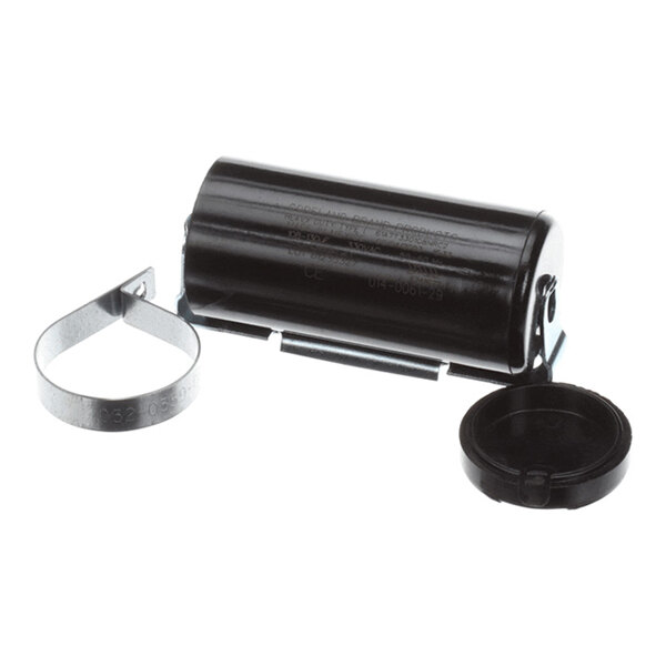 A black cylindrical component with a metal mounting bracket and a detached round plastic cap, likely an electrical capacitor kit.