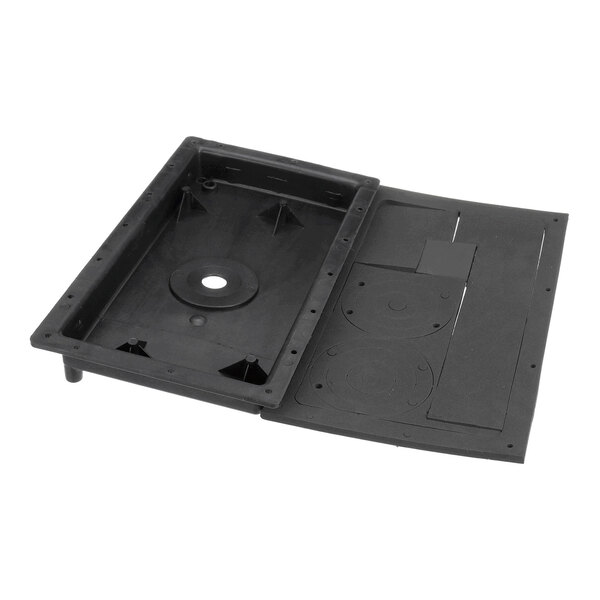 A rectangular black plastic component with a recessed section, a central circular hole, and various molded details and cutouts.