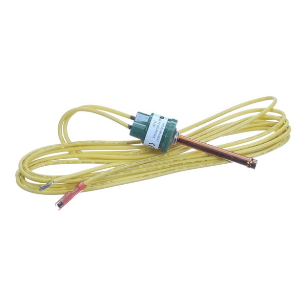 A yellow wire with a green cylindrical component and a copper tube attached, likely part of an electrical or HVAC system.