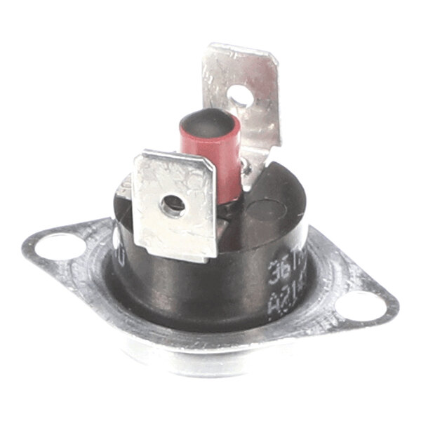 A close-up view of a small round electronic component with two metal terminals and a red push button mounted on a metal flange with two screw holes.