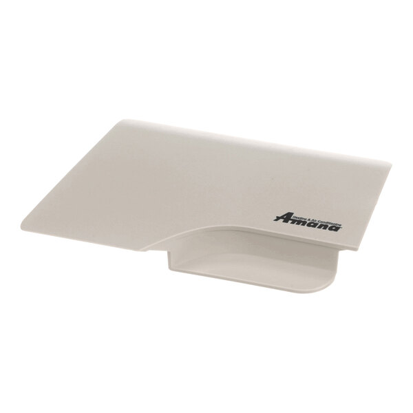 A beige, rectangular plastic component with a flip-down design and the Amana logo printed on it.