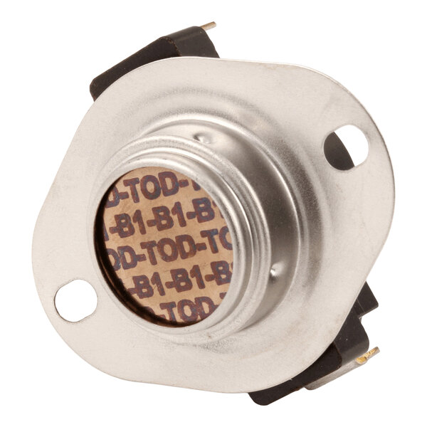 A close-up view of a round metallic component with two mounting holes and a patterned label in the center.