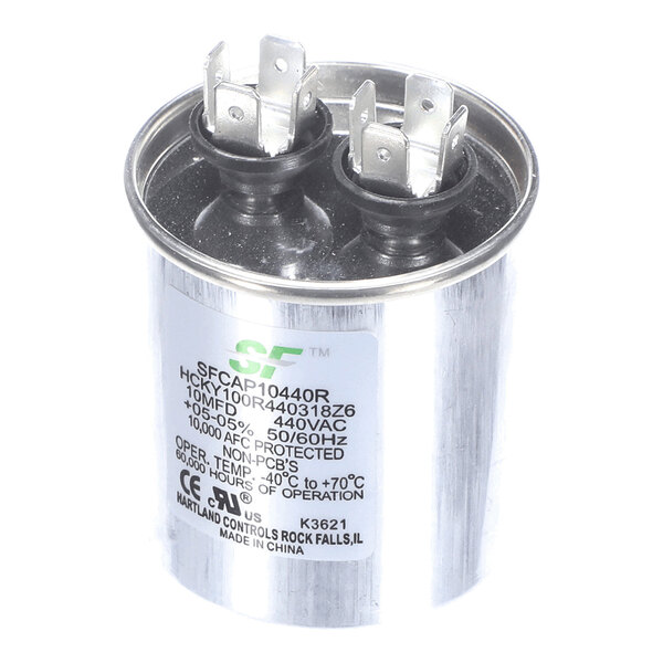 A cylindrical metal capacitor with two sets of electrical terminals on top and a label displaying technical specifications.