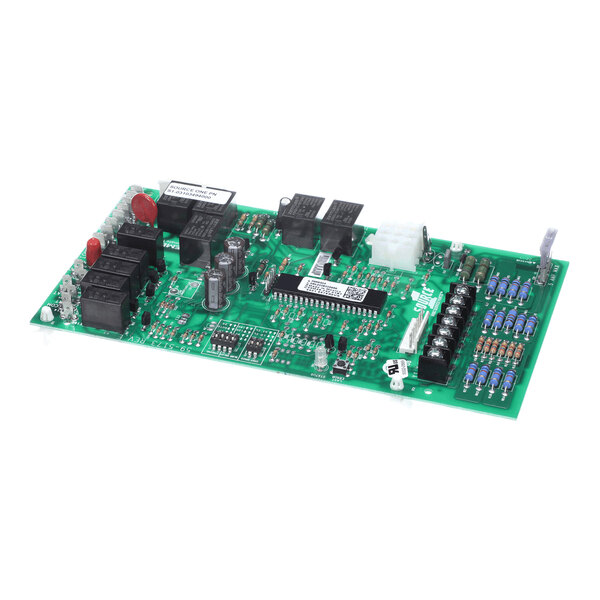 A green electronic circuit board with various components including relays, capacitors, resistors, and connectors mounted on its surface.