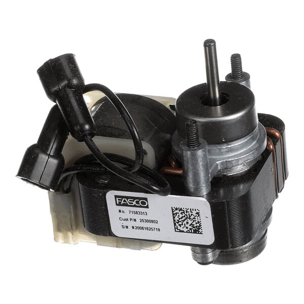 A small electric motor with a label, wiring, and a metal shaft visible.