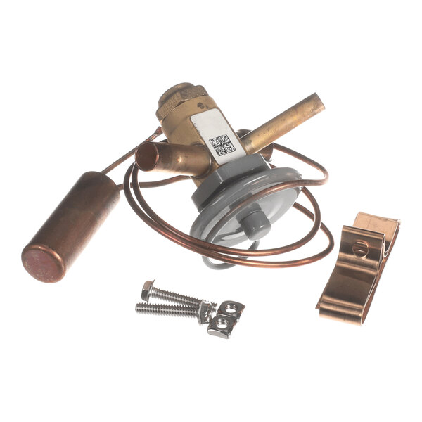 A metal valve assembly with attached copper tubing, a cylindrical component, a mounting clip, and screws, all placed on a white background.