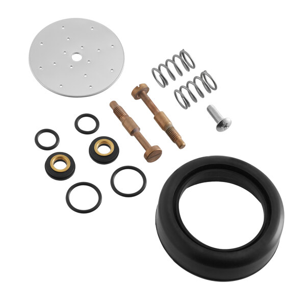 A black rubber wheel with a brown metal circular object and black and gold gaskets on a table.