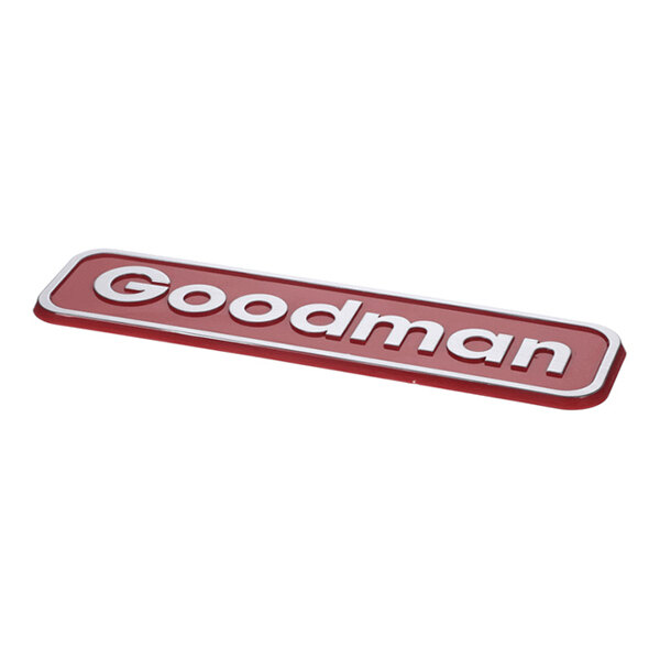 A red and white nameplate with the word 'Goodman' in raised letters.